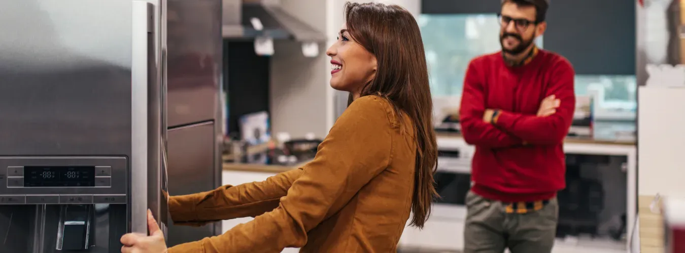 young-couple-looking-at-refrigerators